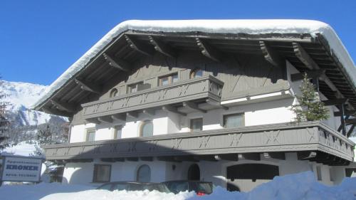 a large building with snow on the top of it at Appartements Kroner in Nauders