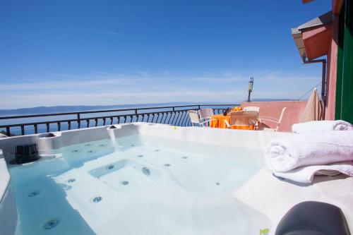 a jacuzzi tub on top of a balcony at panoramic sea view house in Tučepi