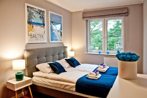 מיטה או מיטות בחדר ב-BlueApart Apartamenty Jurata