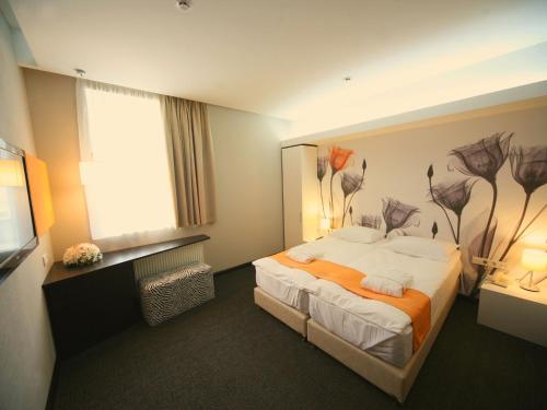 Кровать или кровати в номере City Park Hotel by CHM