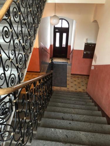 a staircase in a building with a black door at Sarah's Altstadt Oase Salzburg in Salzburg