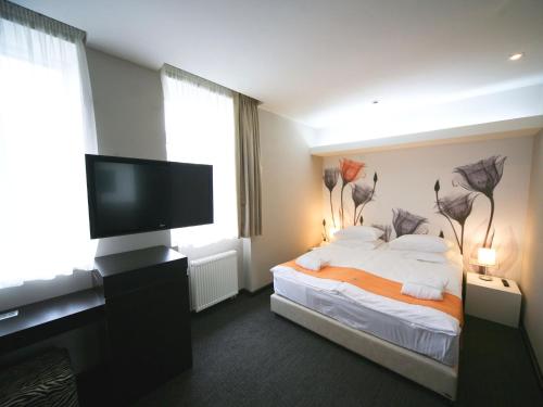 Кровать или кровати в номере City Park Hotel by CHM