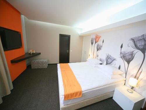Кровать или кровати в номере City Park Hotel by CHM