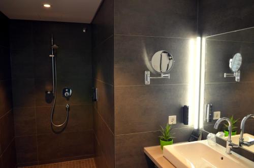 a bathroom with a shower and a sink at Hotel St Elisabeth in Allensbach