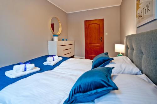 Ένα ή περισσότερα κρεβάτια σε δωμάτιο στο BlueApart Apartamenty Jurata