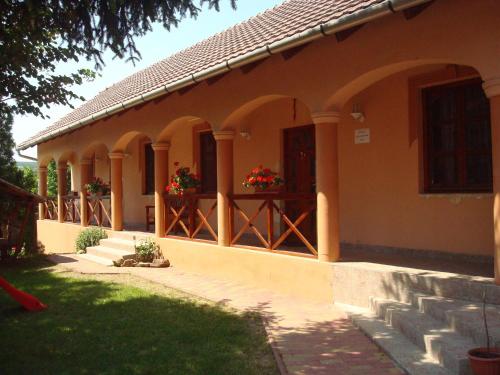 a house with flower boxes on the front of it at Tímea Vendégház in Demjén