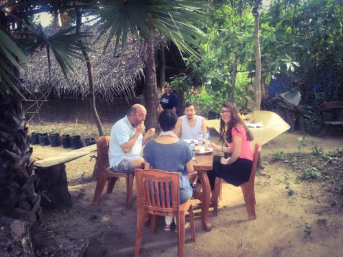 a group of people sitting around a table at Yapahuwa Relax Stay in Yapahuwa