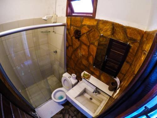 a bathroom with a shower and a toilet and a sink at Pousada Lua Estrela in Canoa Quebrada