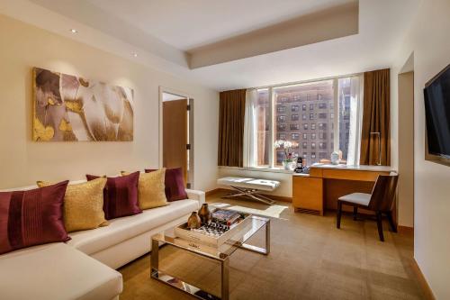 a living room with a couch and a table at Concorde Hotel New York in New York