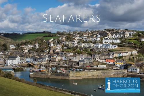 a town on a hill with a river and houses at Seafarers - Coastguard Cottage with sea views, garden and parking in Mevagissey