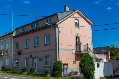 a large pink building on the side of a street at Casa BRAIS in Barreiros