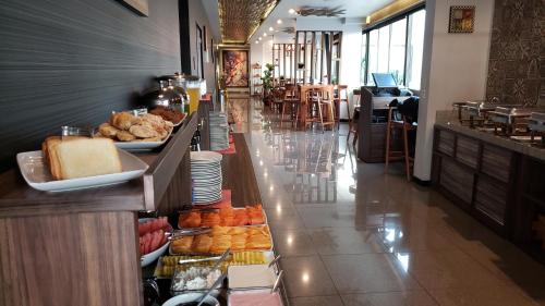 a buffet line with bread and pastries in a restaurant at Terrass Hotel Zamora in Zamora de Hidalgo