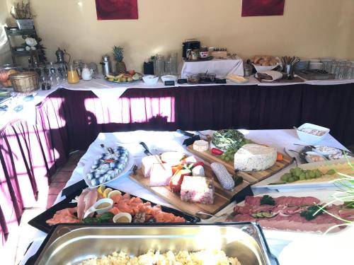 a table topped with lots of different types of food at Hotel Hoxter Am Jakobsweg in Höxter