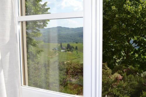an open window with a view of a field at Terre di Melazzano - Le Case di Chiara in Greve in Chianti