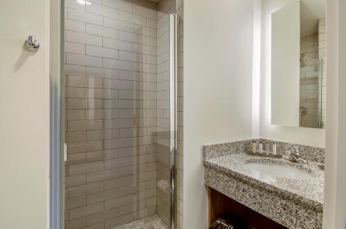a bathroom with a sink and a shower at New Bedford Harbor Hotel, Ascend Hotel Collection in New Bedford