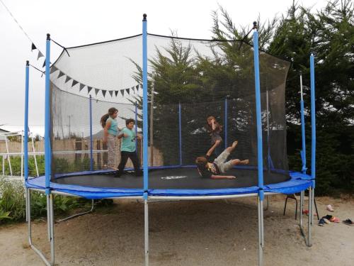 a group of people playing on a trampoline at Hotel Del Valle Quilimari in Pichidangui