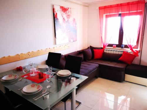 ein Wohnzimmer mit einem Sofa und einem Tisch in der Unterkunft Apartman "Sabine red" with pool in Omišalj
