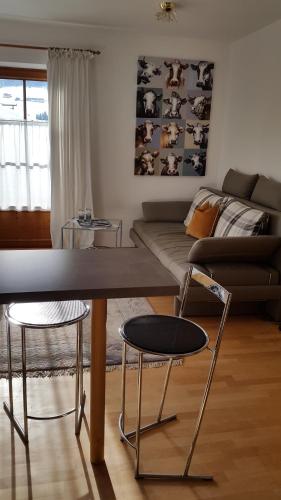 a living room with a table and two chairs at Haus Schönblick - wunderbare Zentrumslage in Alpbach