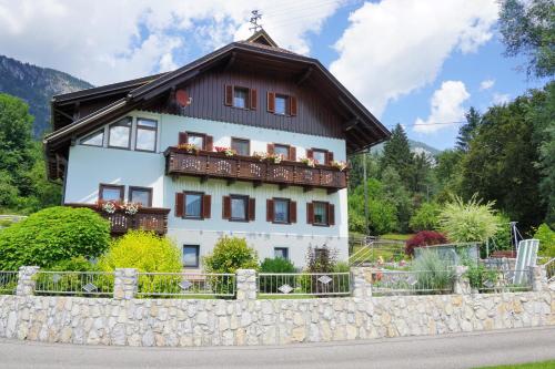 a large white house with a brown roof at Gästehaus im Wiesengrund in Sankt Stefan an der Gail