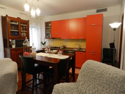 a kitchen with red cabinets and a table with chairs at B&B Joe in Valguarnera Caropepe
