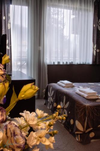 a bedroom with a bed and a window with white curtains at Ostrova Holiday Village in Beli Osŭm