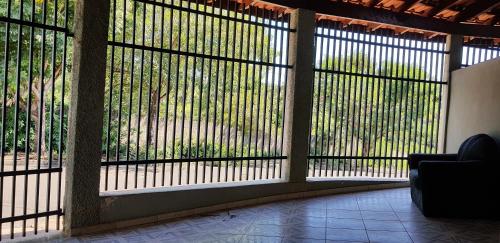 a room with a large window with bars on it at Casa da Cachoeira in Brotas