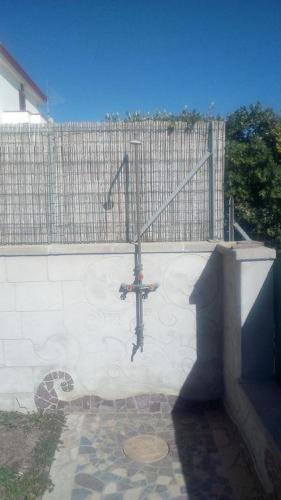 a wall with a fence with a bike on it at Villa Rosa in SantʼAntìoco