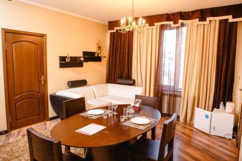 a living room with a table and a couch at Totem Hotel in Shymkent