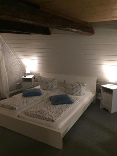 a bedroom with two beds with pillows and two lamps at Himmel & Hölle in Quedlinburg