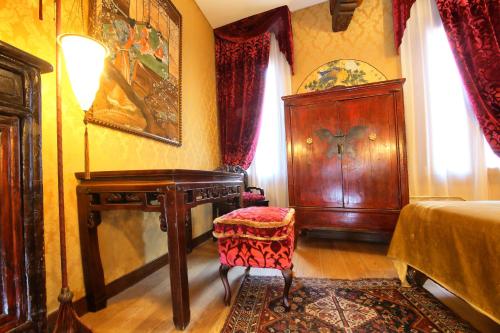 a bedroom with a bed and a table and a chair at Ca' Pagan in Venice