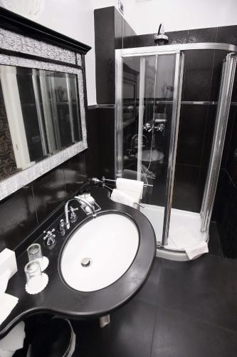 a black bathroom with a sink and a window at Ca' Pagan in Venice