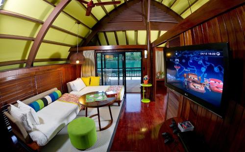 a room with a tv and a bed and a couch at Holiday Inn Resort Vanuatu by IHG in Port Vila