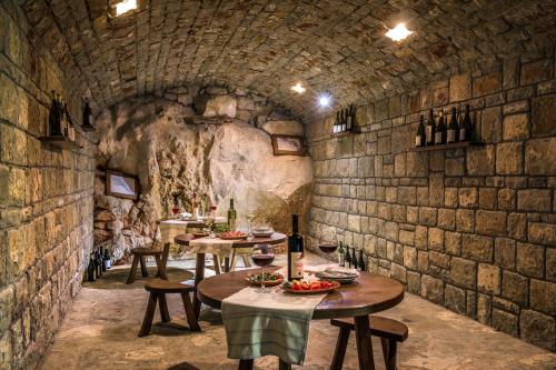 a wine tasting room with tables and wine bottles at Radisson Resort Ruza Vjetrova in Dobra Voda