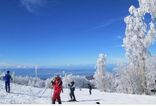 a group of people on skis in the snow at Green Park Hotel & Residence in Bagnara Calabra