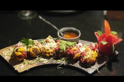 a plate of food on a table with food at Hotel Stellar in Vadodara