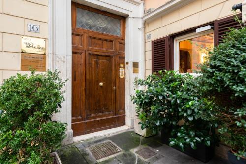 a wooden door on the side of a building at Rome in your heart - Spagna Single Room in Rome