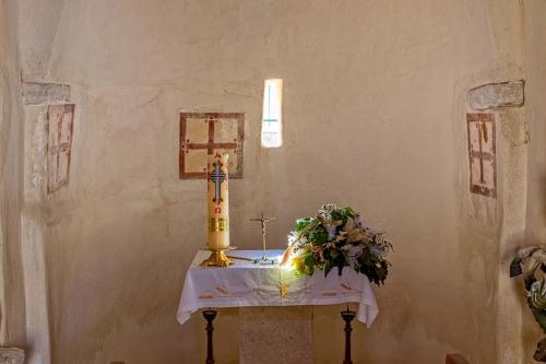 a table with a cake and a cross on it at Villa Bougenvilia Tomas in Tučepi