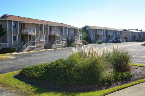 a row of apartment buildings with a parking lot at Sea Scape Beach and Golf Villas in Kitty Hawk