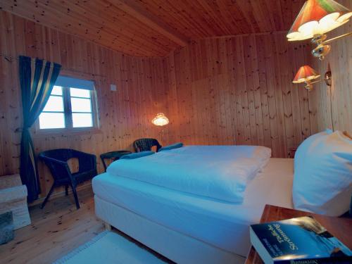 a bedroom with a bed and a table and a window at Seaside View Lofoten in Bøstad