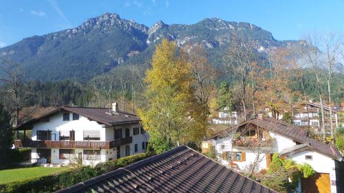 a group of houses in front of a mountain at Yeti Lux - Family Garden Lodge in Garmisch-Partenkirchen