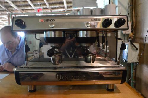 a man is standing next to a coffee machine at Kukulcan by Emotion in Tulum