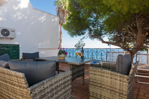 a patio with a table and chairs and a tree at Villa Mallandrino in Mondello