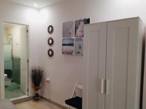 a bathroom with a white cabinet and a mirror at La Joya de la Caleta. A 60 mts playa. in Cádiz