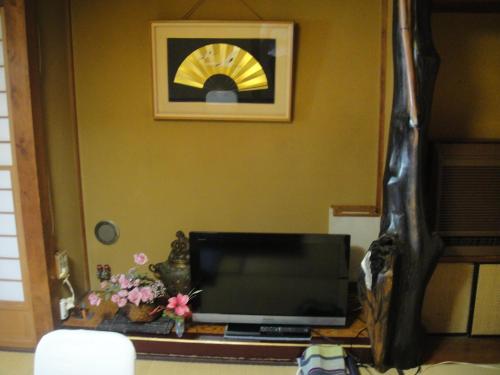 a television sitting on a table in a room at Kurhaus Ishibashi Ryokan in Shimoda