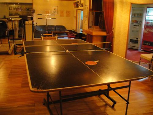 a ping pong table in the middle of a room at Kurhaus Ishibashi Ryokan in Shimoda