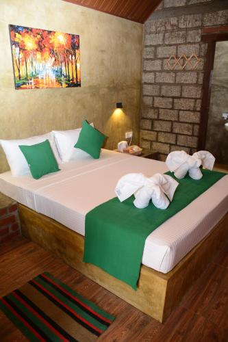 a bedroom with a large bed with towels on it at Negombo The Nature Villa and Cabanas in Negombo