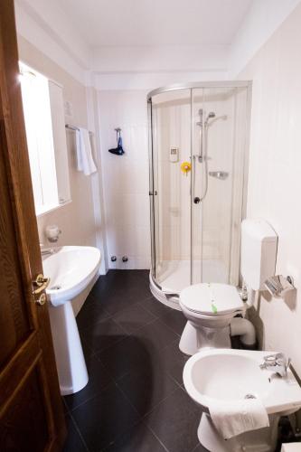 a bathroom with a shower and a toilet and a sink at Hotel AmaDeus in Focşani
