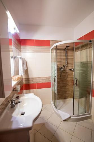 a bathroom with a sink and a shower at Hotel AmaDeus in Focşani