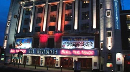 a large building with neon signs in front of it at Circle Guest House Bed Only in Southampton
