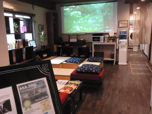 a room with a large screen with a video game at Sumiya Spa & Hotel in Hiroshima
